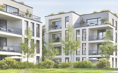 Modern white apartment buildings with multiple balconies, surrounded by a green lawn and trees in a sunny courtyard.